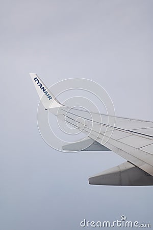 06/09/2021. Commercial Ryanair airborne airplane at high altitude. Cabin window view at wing with company name. Editorial Stock Photo