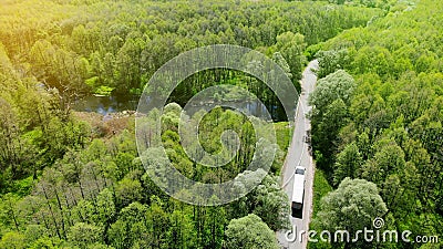 Commercial truck driving along the rural road between forest Stock Photo