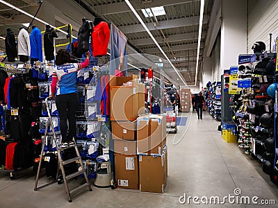 Commercial worker arranging the products at Decathlon Editorial Stock Photo