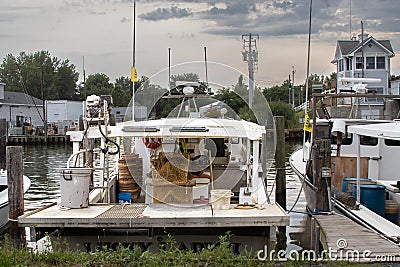 Commerical working fishing, crabbing and oystering boat in a marina on Tilghman Island on a stormy afternoon in the summer. Stock Photo