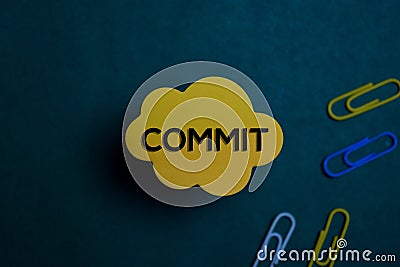 Commit write on a sticky note isolated on Office Desk Stock Photo