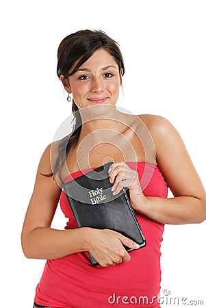 Committed christian holding a bible and smiling Stock Photo