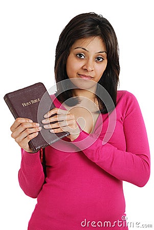 Committed christian holding a bible and smiling Stock Photo