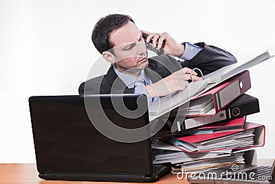 Committed employee checking file at phone Stock Photo