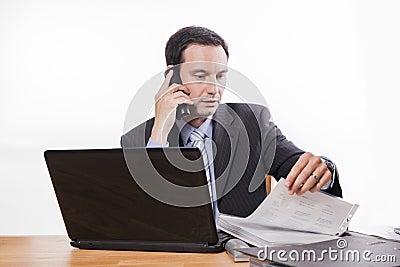 Committed employee checking files at phone Stock Photo