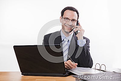 Committed employee with glasses smiling at phone Stock Photo