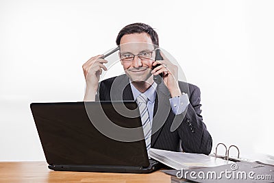 Committed employee with glasses smiling at phone Stock Photo