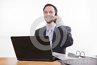 Committed employee smiling at phone Stock Photo