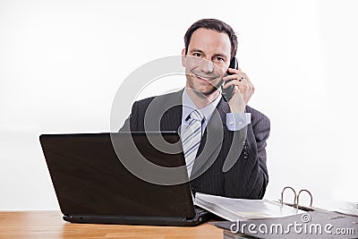 Committed employee smiling at phone Stock Photo