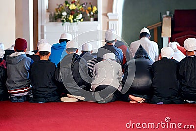 Committed to their faith. people worshipping in a mosque. Editorial Stock Photo