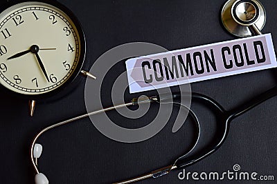 Common Cold on the paper with Healthcare Concept Inspiration. alarm clock, Black stethoscope. Stock Photo