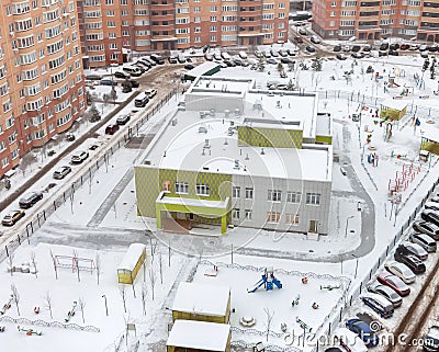 Common establishments building and residential settings house in residential area after winter snow Stock Photo