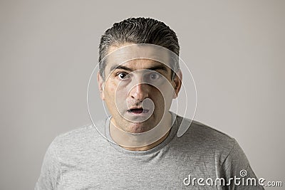 Common man in shock surprise and disbelief face expression in feelings and emotions concept isolated on grey Stock Photo