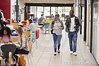 Communal Area Of Busy College Campus With Students Stock Photo