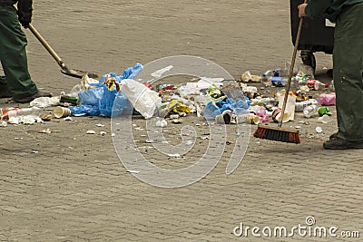 Communal service workers clean street from garbage Stock Photo