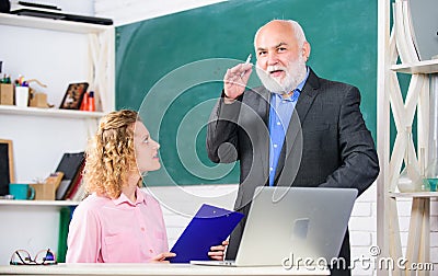 Communicate clearly and effectively. Work in education. Man mature school teacher and girl student with laptop. High Stock Photo