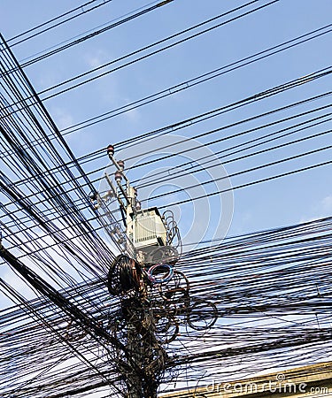 The communication cables are entangled on the electric pole Stock Photo