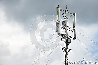 Communication cellular signal tower. 3G, 4G, 5G phone signal base station. Urban antenna repeater tower. Storm warning Stock Photo