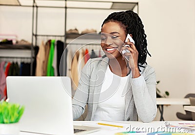 Communication with suppliers. Woman tailor talking on phone Stock Photo