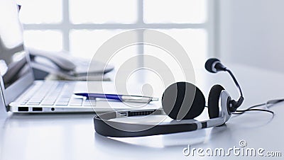 Communication support, call center and customer service help desk. VOIP headset on laptop computer keyboard Stock Photo