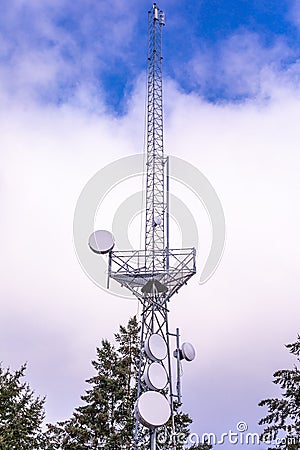 Communication tower with group of parabolic antennas Stock Photo