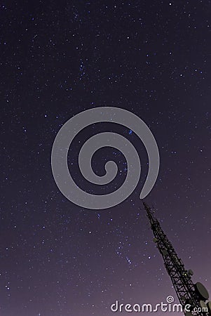 Communication tower pointing up to the stars Stock Photo