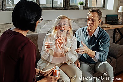 Communicative good-looking couple actively talking to a psychotherapist Stock Photo