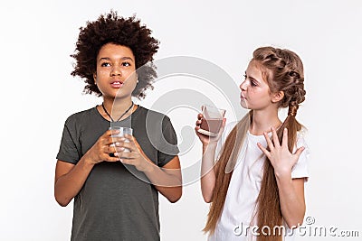 Communicative young lady telling interesting story to her friend Stock Photo