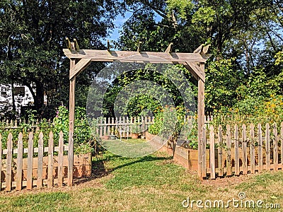 Community garden with wood fence, entrance to garden Stock Photo