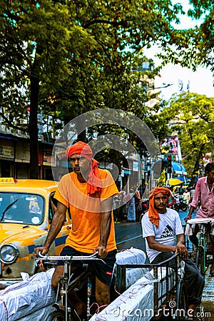 A commuter carrying luggage in a rickshaw Editorial Stock Photo