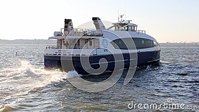 Commuter ferry boat OPPORTUNITY leaving Brooklyn Army Terminal pier, rear view, New York, NY Editorial Stock Photo