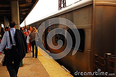 Commuters prepare to board the train during the morning rush Editorial Stock Photo