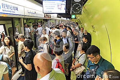 Commuters waiting for a train in the MTR Wan Chai in Hong Kong Editorial Stock Photo