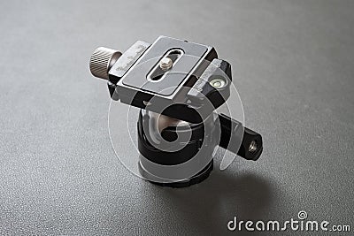 A compact ballhead tripod head in a dark background Stock Photo