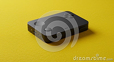 A compact, black handheld device with rounded edges and multiple buttons on its Stock Photo