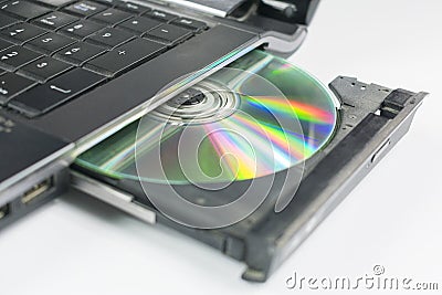 Insert a CD into the laptop Stock Photo