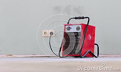 Compact red heater, drying the floor Stock Photo