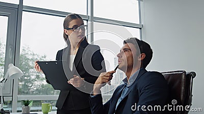 Company boss give instruction in office closeup. Beautiful assistant take notes Stock Photo