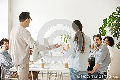 Company boss introducing new hire employee to colleagues, rear v Stock Photo