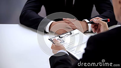Company CEO holding curriculum vitae of employer, making decision, employment Stock Photo