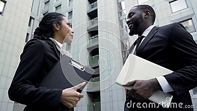 Company employees talking near office building, successful teamwork on project Stock Photo
