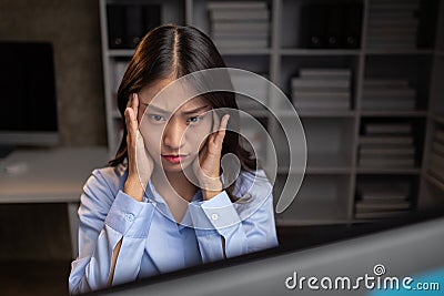 Company employees working overtime after work, working overtime after working hours due to heavy workload, employees are stressed Stock Photo