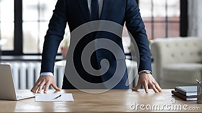 Company executive, CEO, owner in formal suit standing at desk Stock Photo