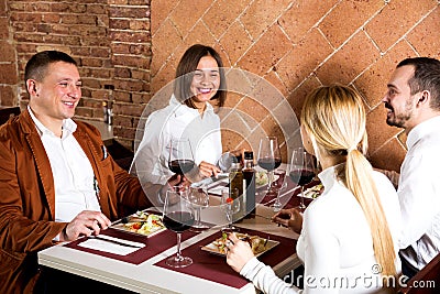 Company of friends eating delicious dinner Stock Photo