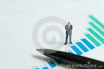 Company growth, stock market return growing revenue and profit concept, miniature figure confidence businessman standing on bar Stock Photo