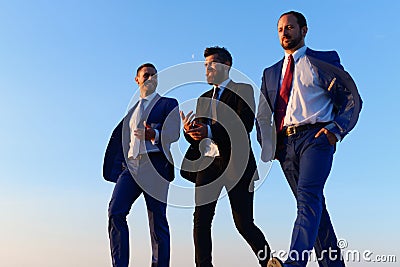 Company leaders take a walk on sunset sky background Stock Photo