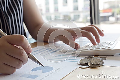 The company`s female accountant is checking the company`s financial account. Stock Photo