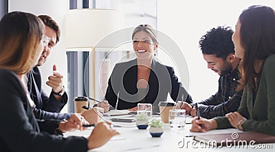 This company thrives on a collaborative work culture. a group of businesspeople having a meeting in a boardroom. Stock Photo