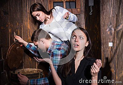 Company of young people trying to solve a conundrum to get out o Stock Photo