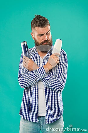 Compare beauty product. Wash hair with shampoo. Hair conditioner or lotion. Make right choice. Man bearded hipster Stock Photo